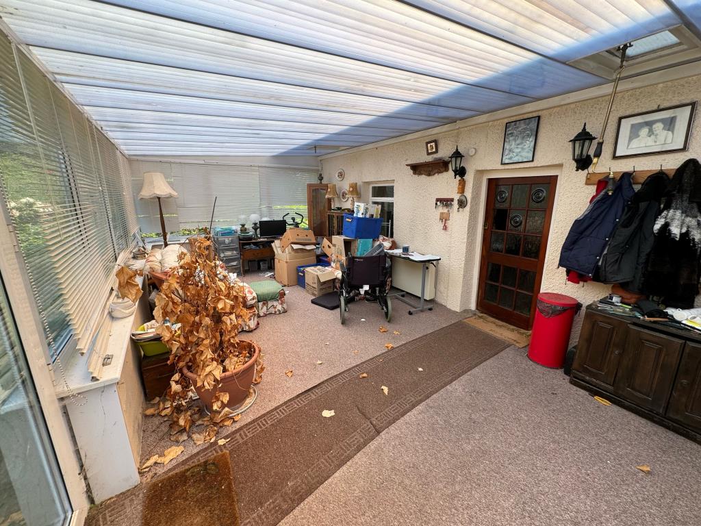 Lot: 126 - ONE-BEDROOM COTTAGE ON A GENEROUS PLOT - General view of the sun lounge